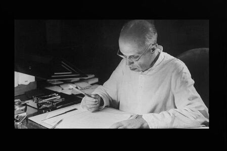 Jawaharlal Nehru working in his writing table at home